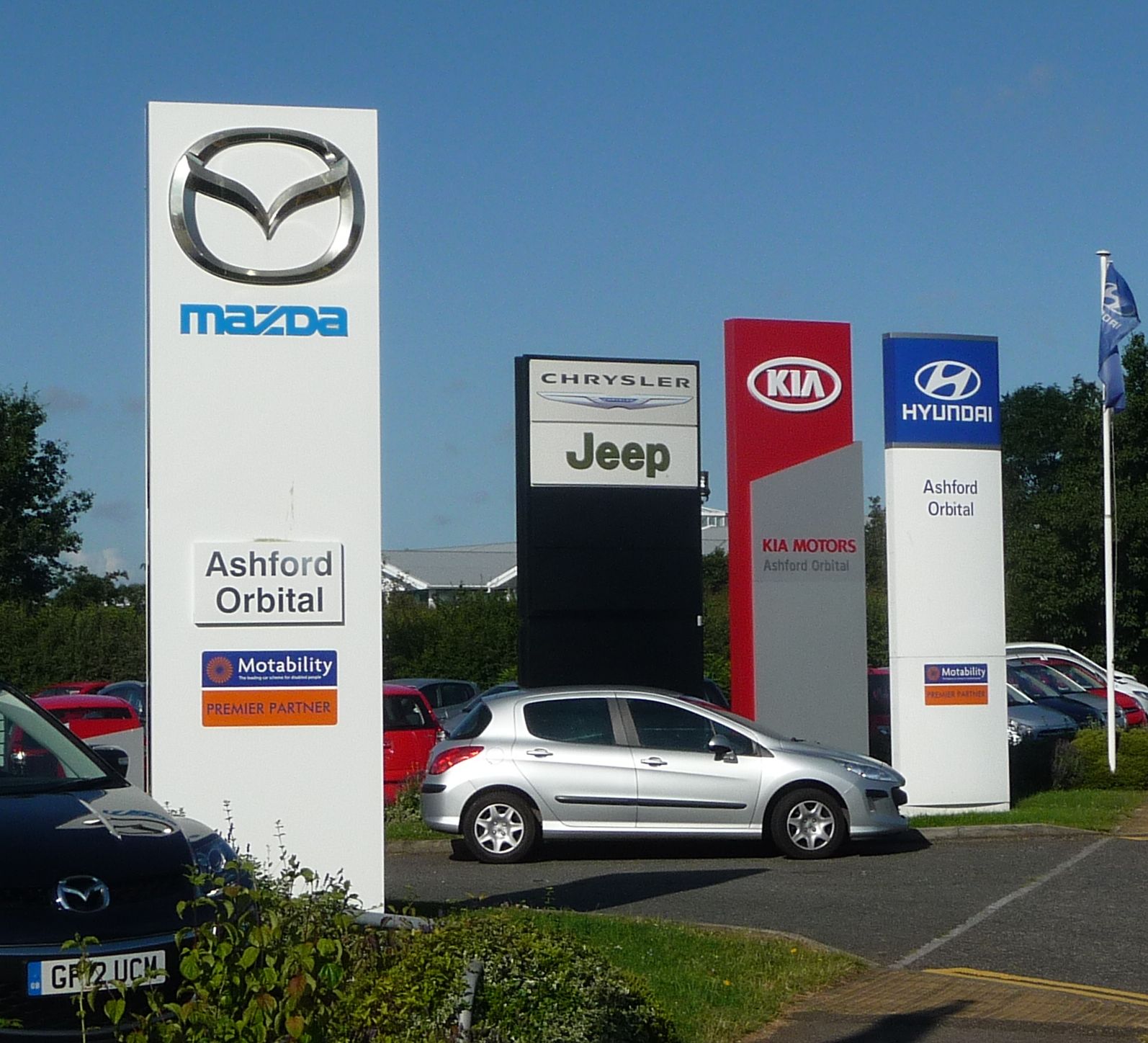 Row of new cars for sale at a dealership lot