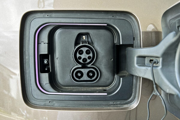 Close-up of an EV charging port inlet on a vehicle